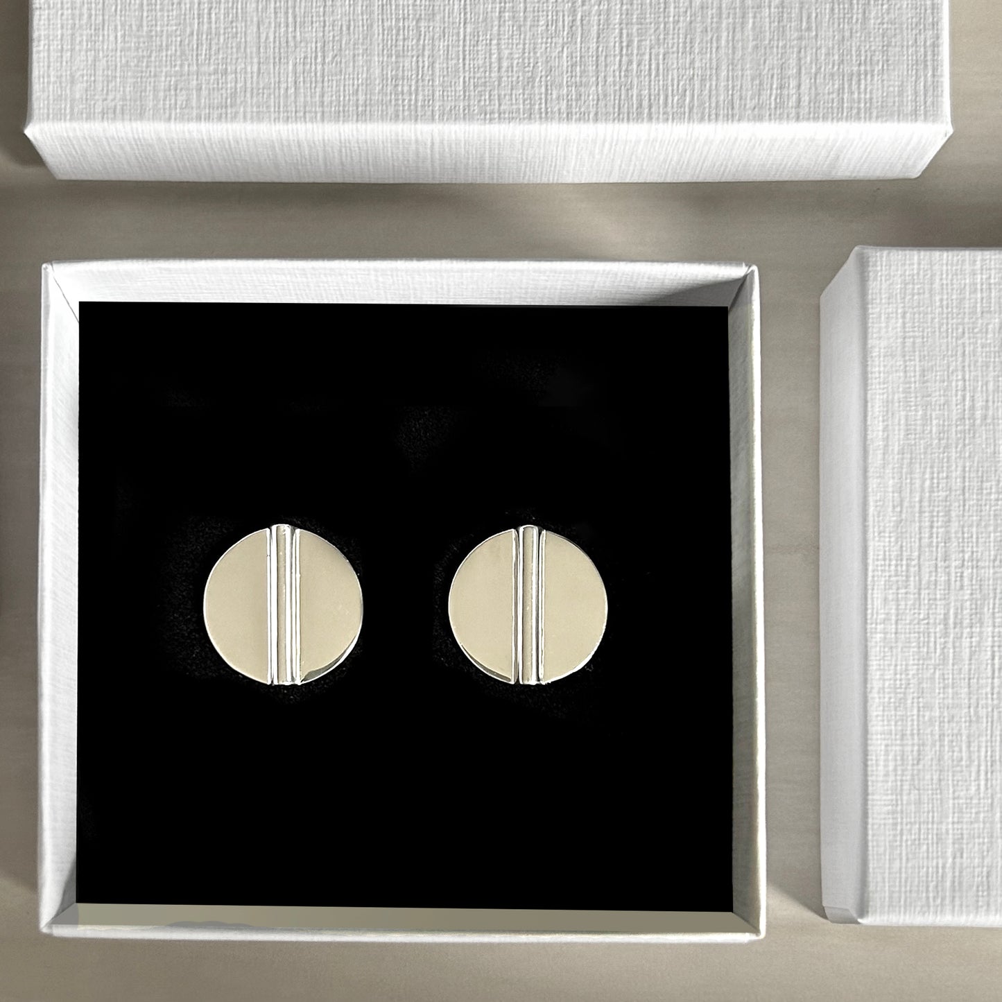 Aegis Modern Silver Coin Earrings in jewelry box