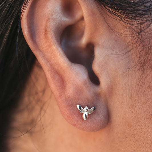 Tiny Bee Stud Earring in silver on ear
