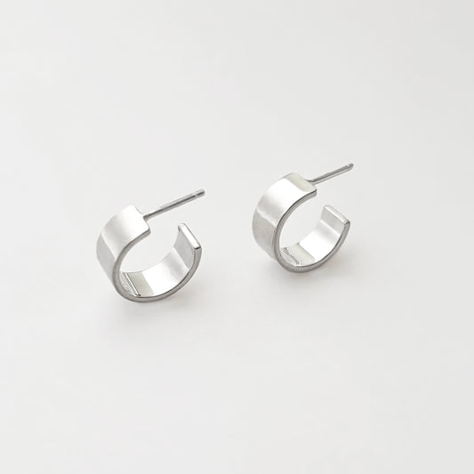 Pair of silver hoop earrings on a light gray background