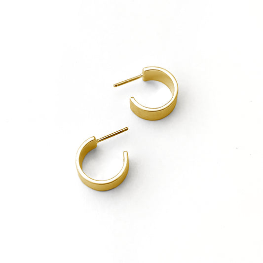 Gold hoop earrings on a white background
