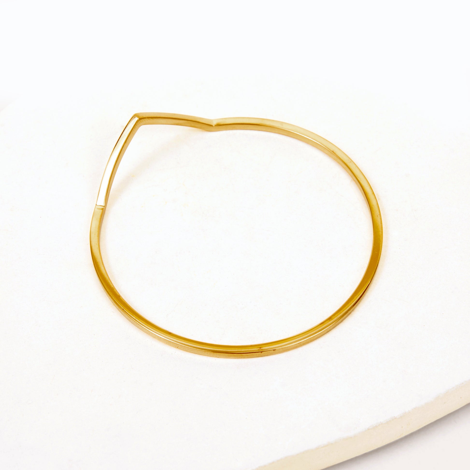 Gold bangle bracelet with triangle shaped V peak