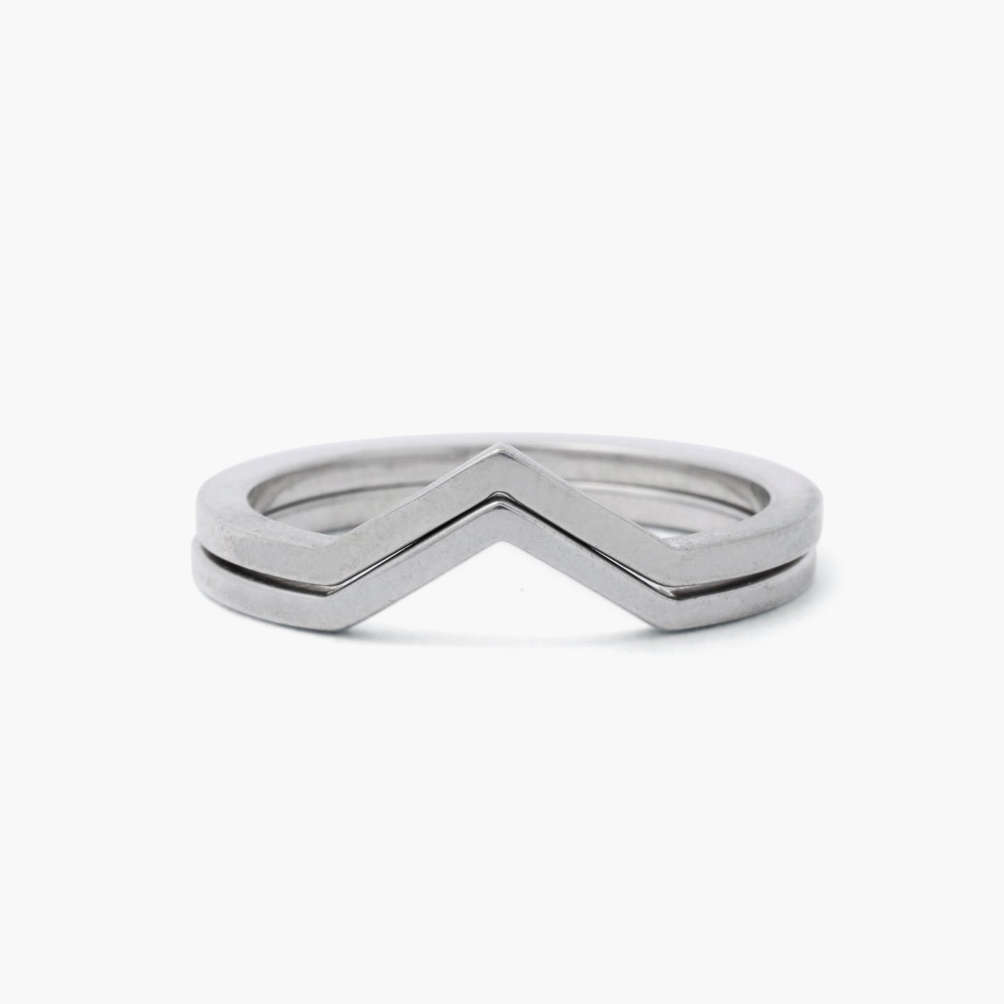 Pair of silver rings stacked on a white background