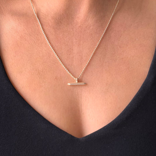 Silver Linear Bar Necklace Pendant hanging on woman's neck
