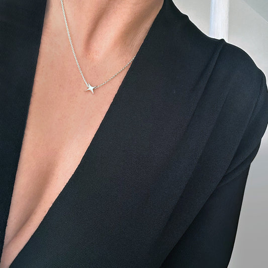 Silver Star necklace atomic starburst on woman's neck