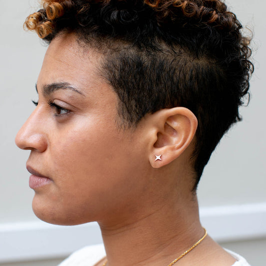 Person wearing a star-shaped stud earring