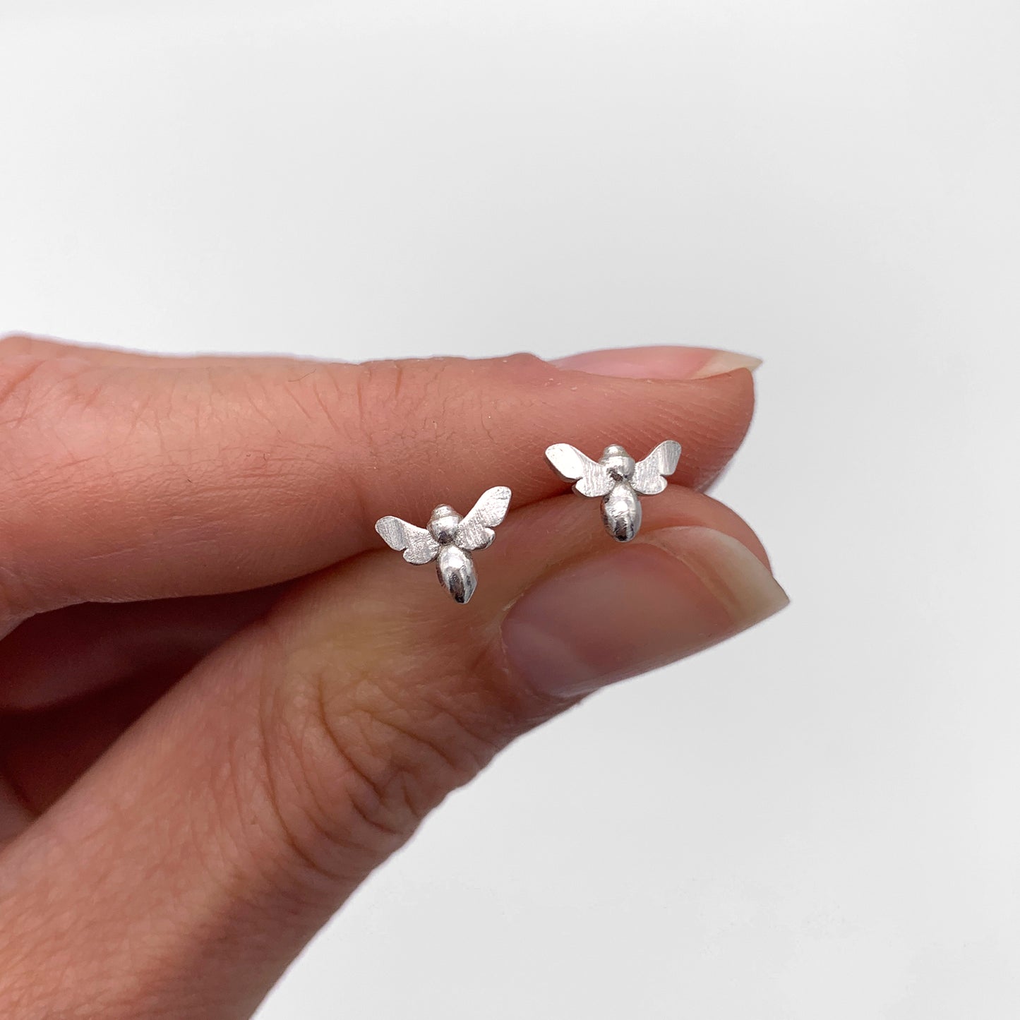 Silver Bee Stud Earrings in Hand