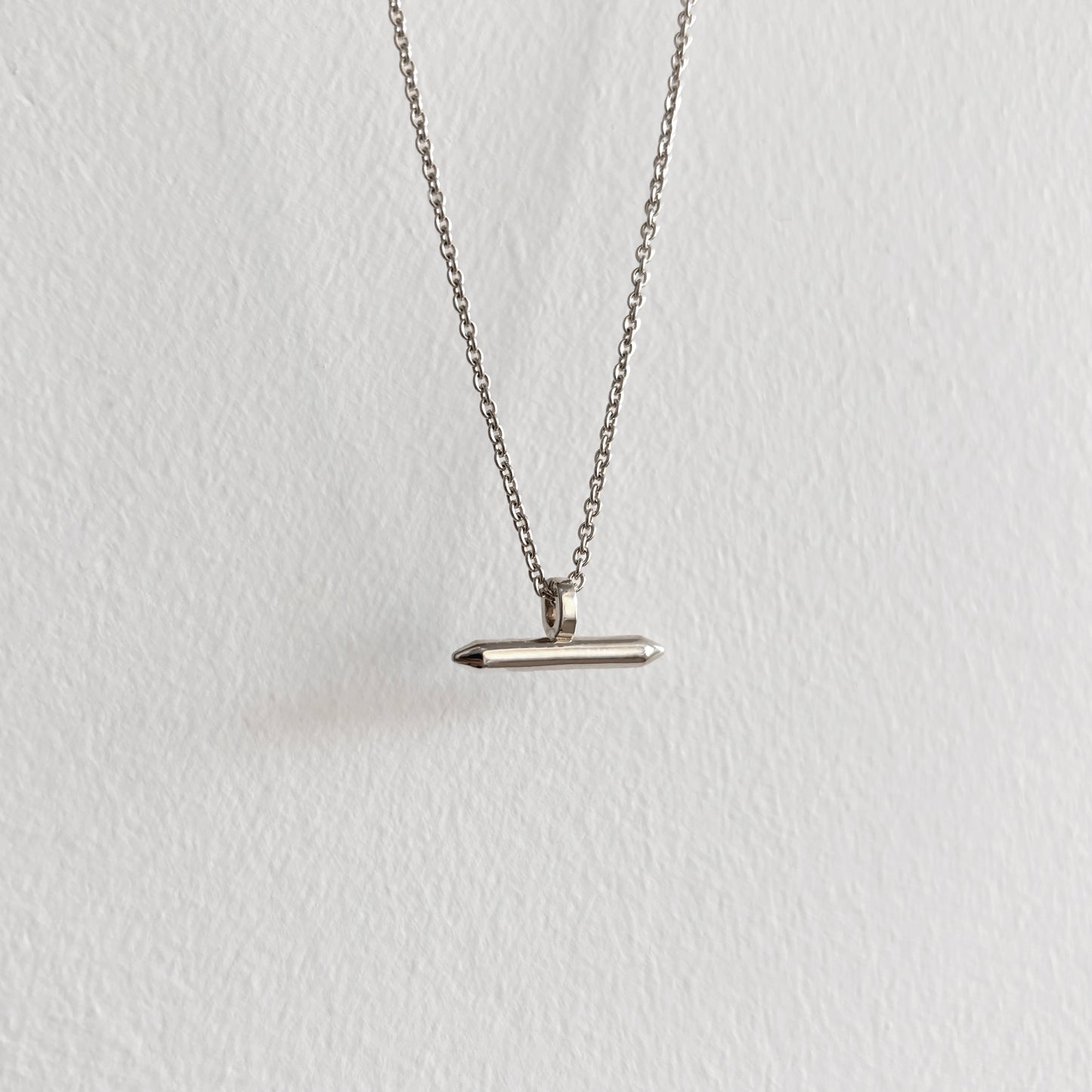 Silver Linear Bar Necklace Pendant hanging on silver chain with white background