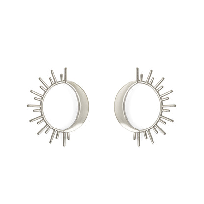 A pair of silver-colored celestial earrings designed with a sun and moon motif.