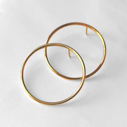 Pair of gold hoop earrings on a white background