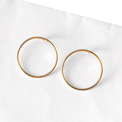 Pair of gold hoop earrings on a white background