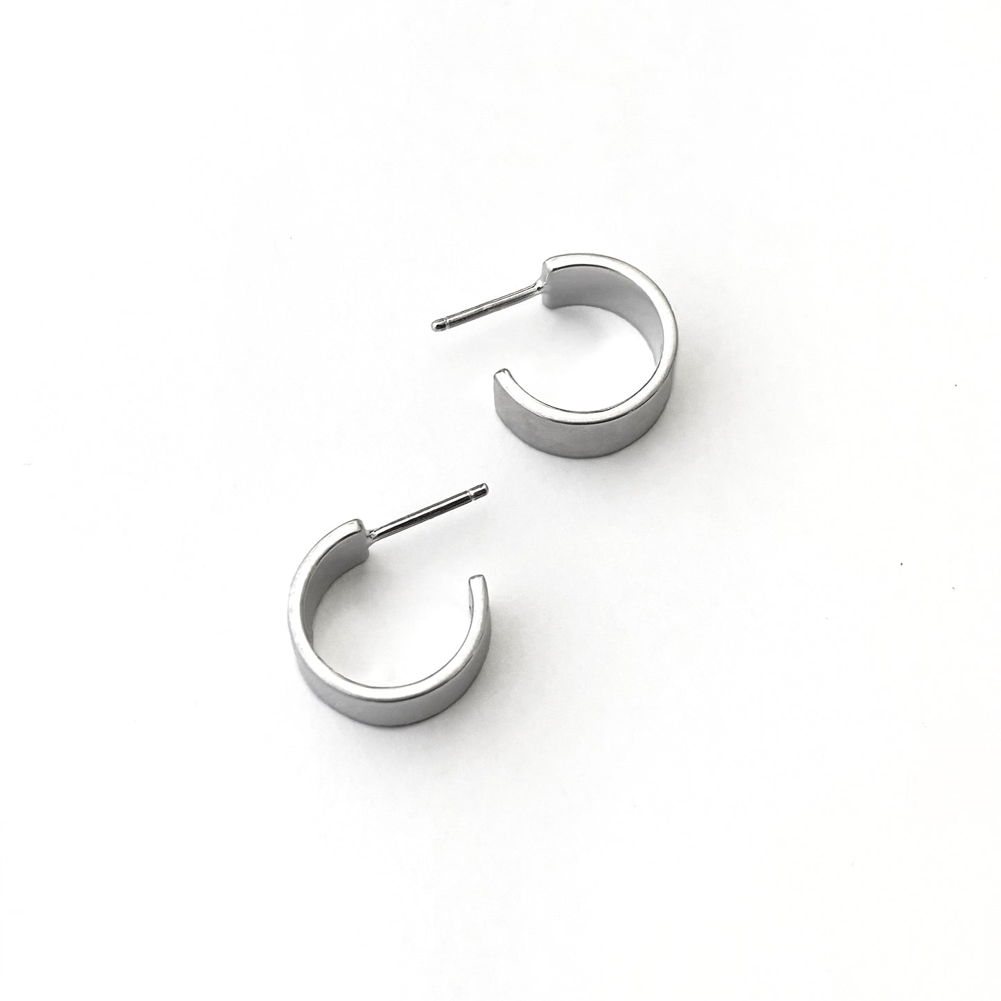 Pair of silver hoop earrings on a white background