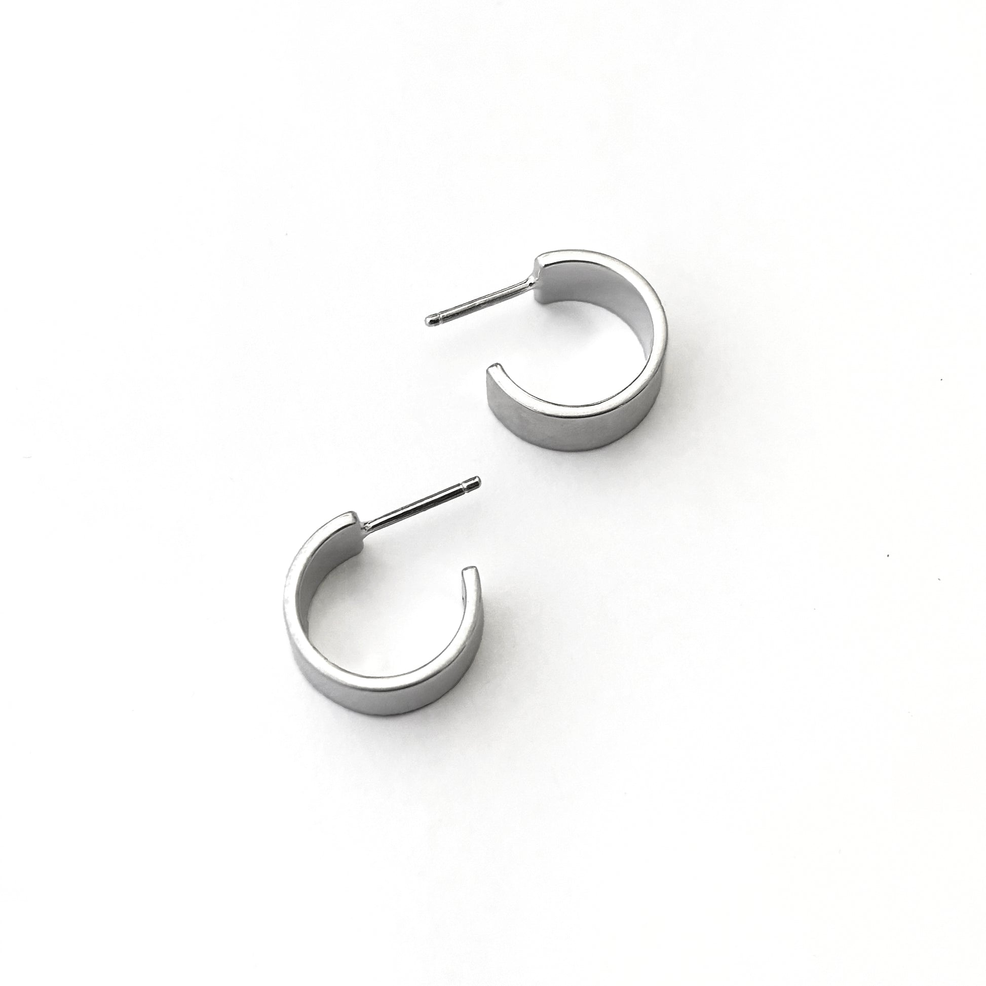 Pair of silver hoop earrings on a white background