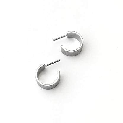Pair of silver hoop earrings on a white background