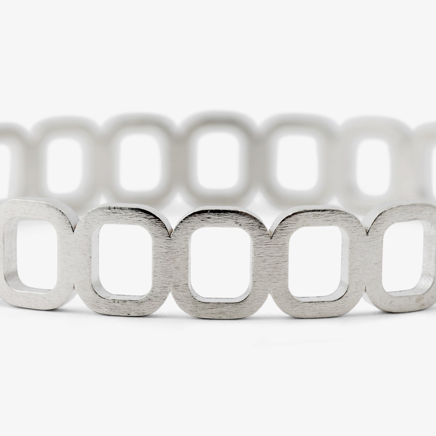 Close up of silver bangle bracelet with rectangular design