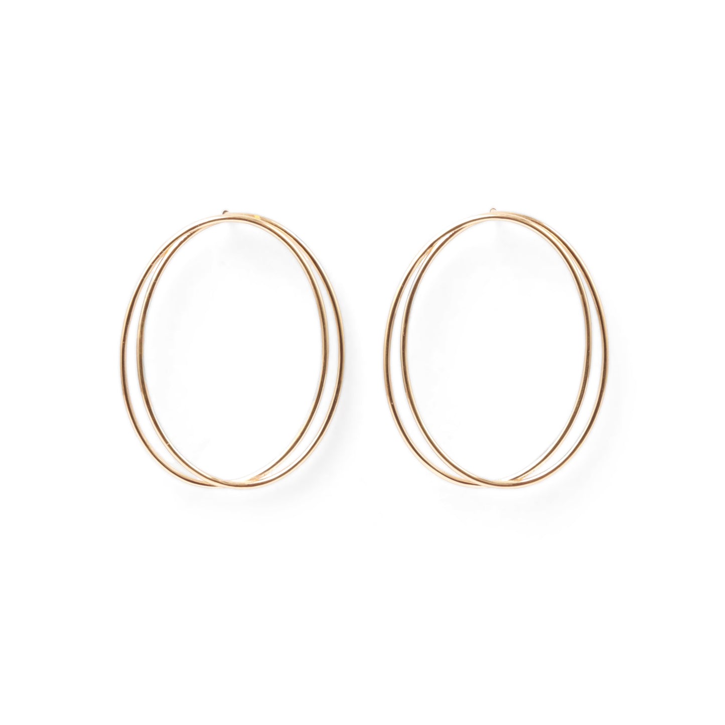 A pair of thin, oval-shaped earrings with a silver finish, displayed against a white background.