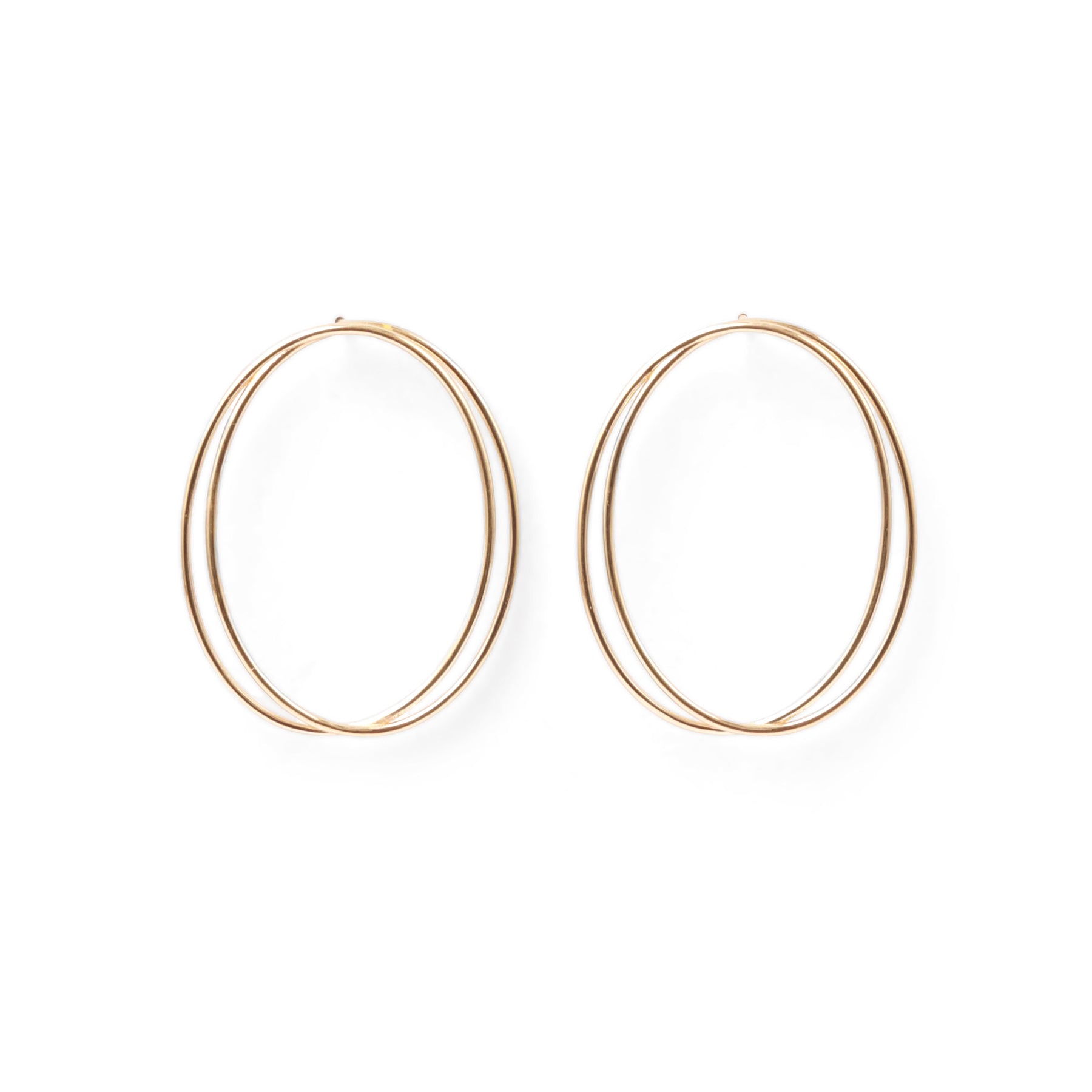 A pair of thin, oval-shaped earrings with a silver finish, displayed against a white background.