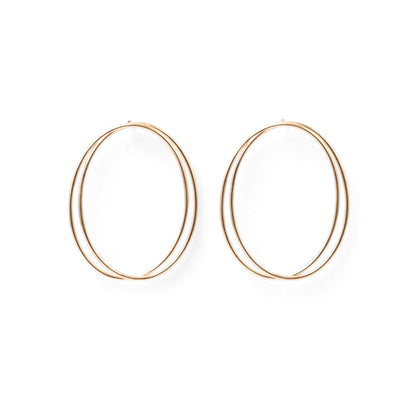 A pair of thin, oval-shaped earrings with a silver finish, displayed against a white background.