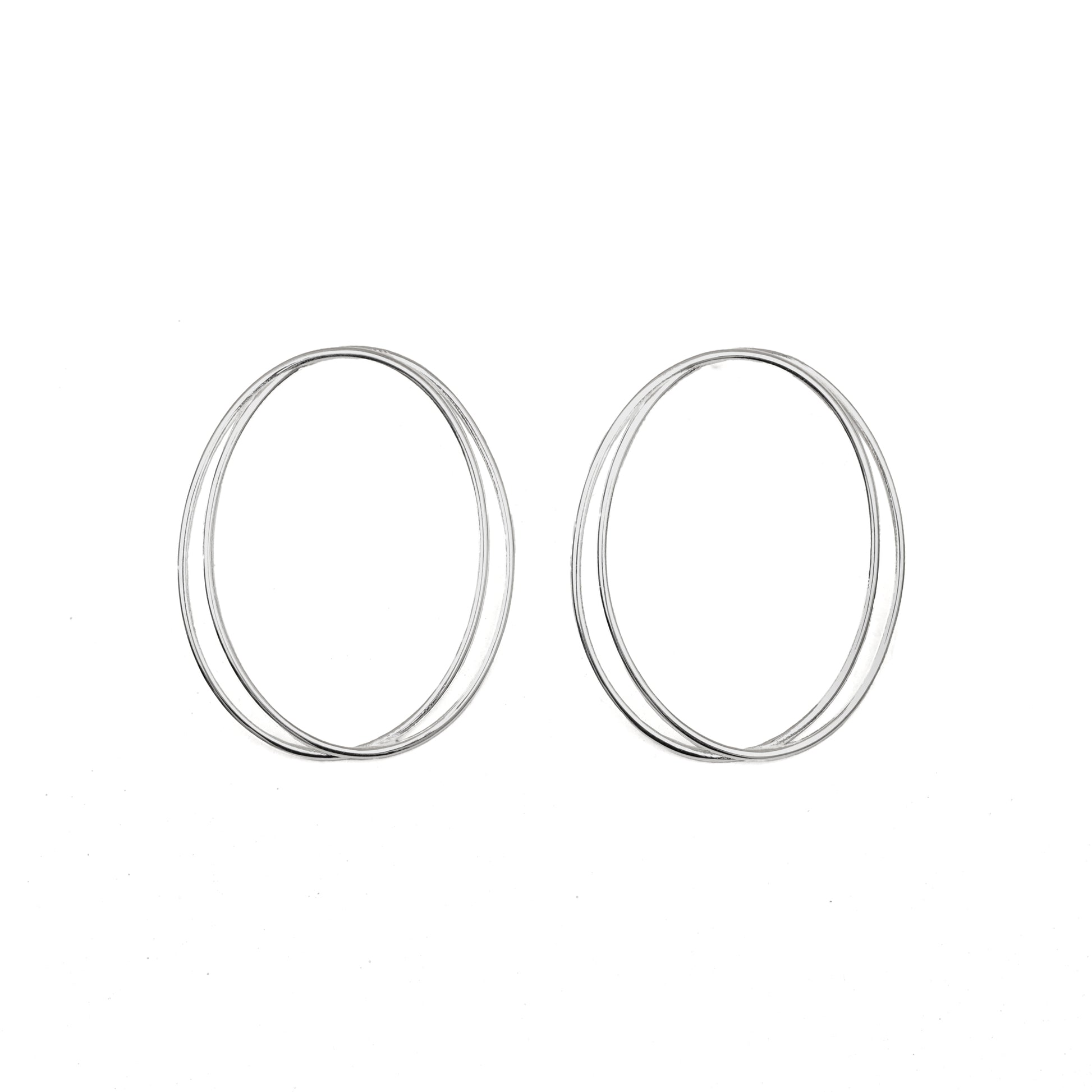 A pair of thin, oval-shaped earrings with a silver finish, displayed against a white background.