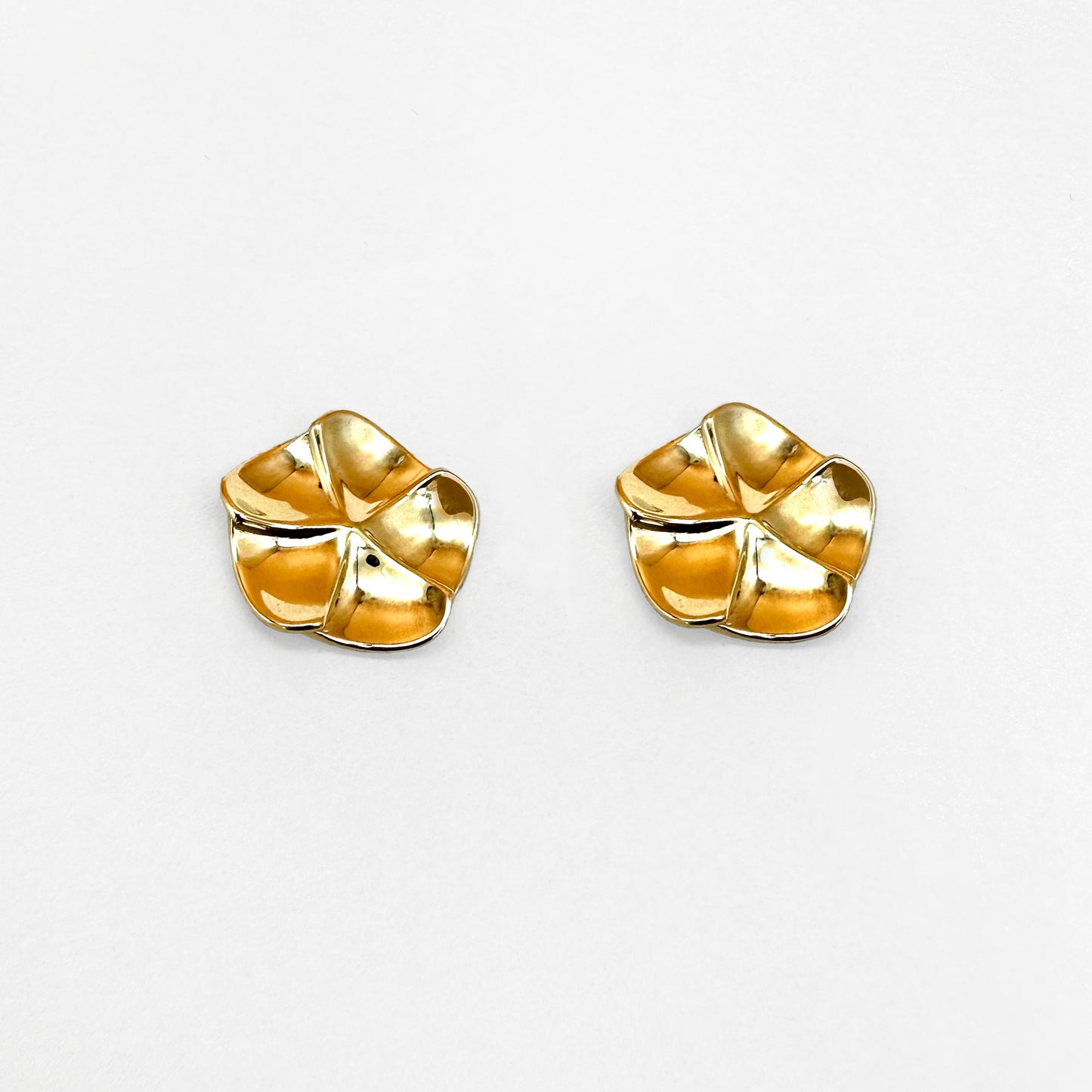 A pair of gold floral design earrings with a post-backing, inspired by flower petals.