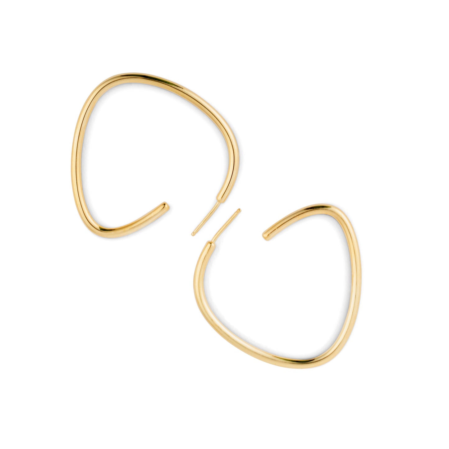 A pair of gold-colored curved hoop earrings against a white background.