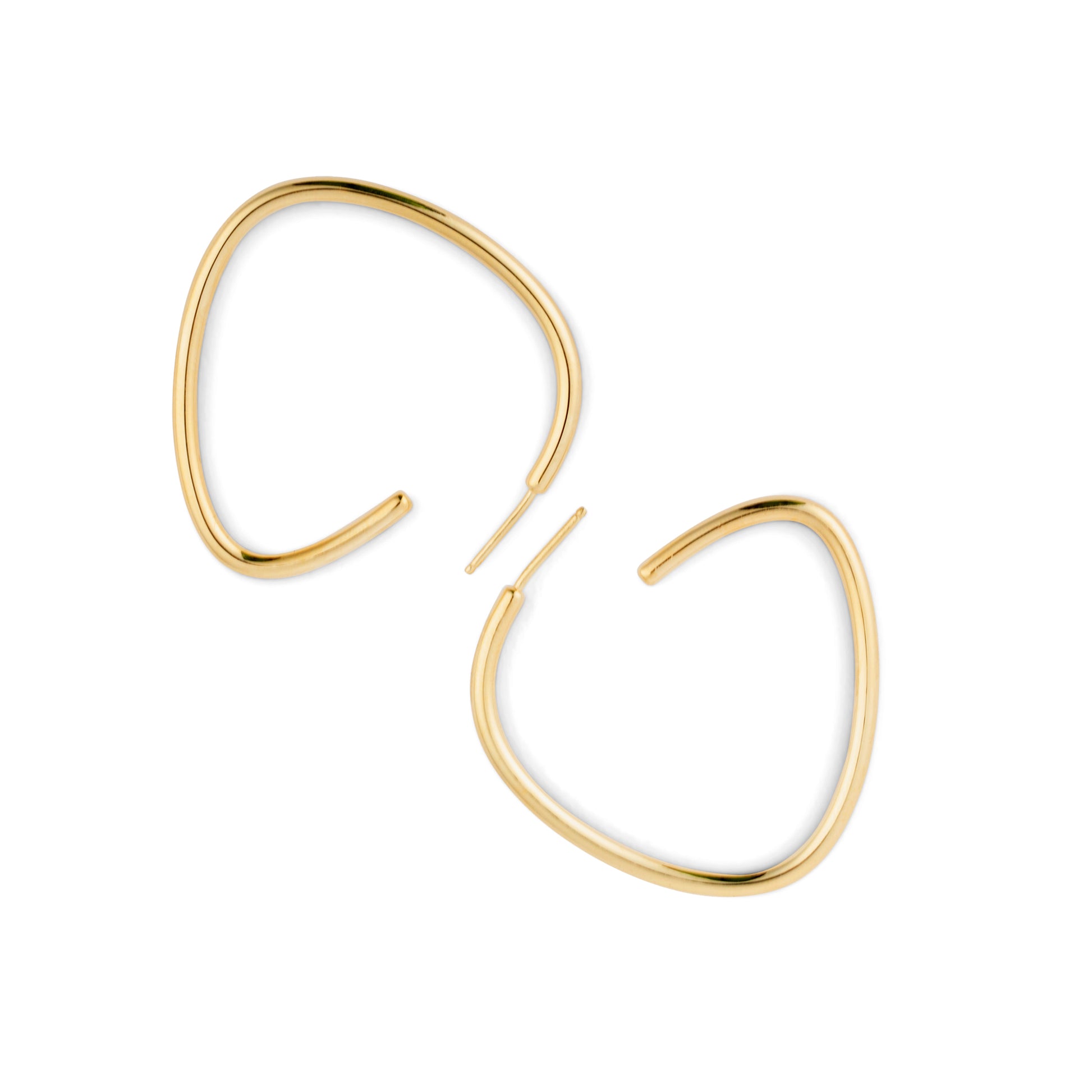 A pair of gold-colored curved hoop earrings against a white background.
