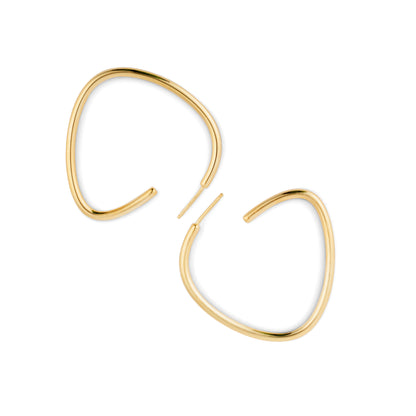 A pair of gold-colored curved hoop earrings against a white background.