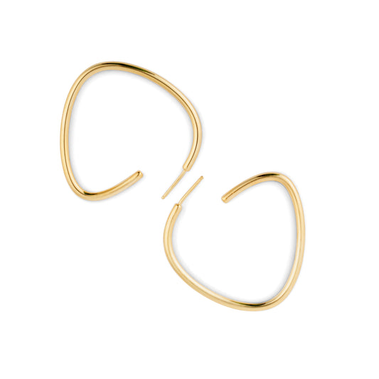 A pair of gold-colored curved hoop earrings against a white background.