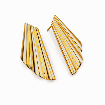 Pair of shell-inspired gold earrings against a white background