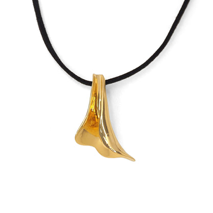 Gold pendant on a black cord against a white background