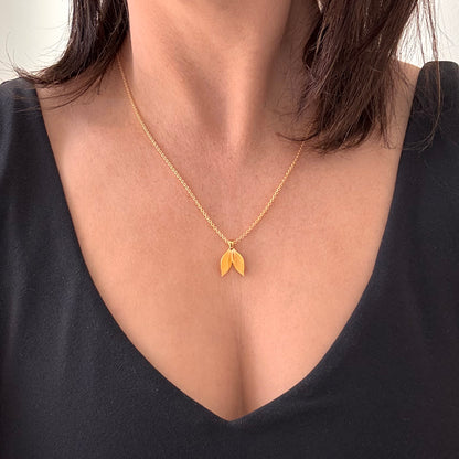 Gold Leaf Necklace Pendant on woman's neck