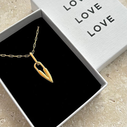 Gold heart necklace in a box with 'LOVE' text