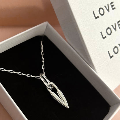 Silver necklace with a heart pendant in an open jewelry box.