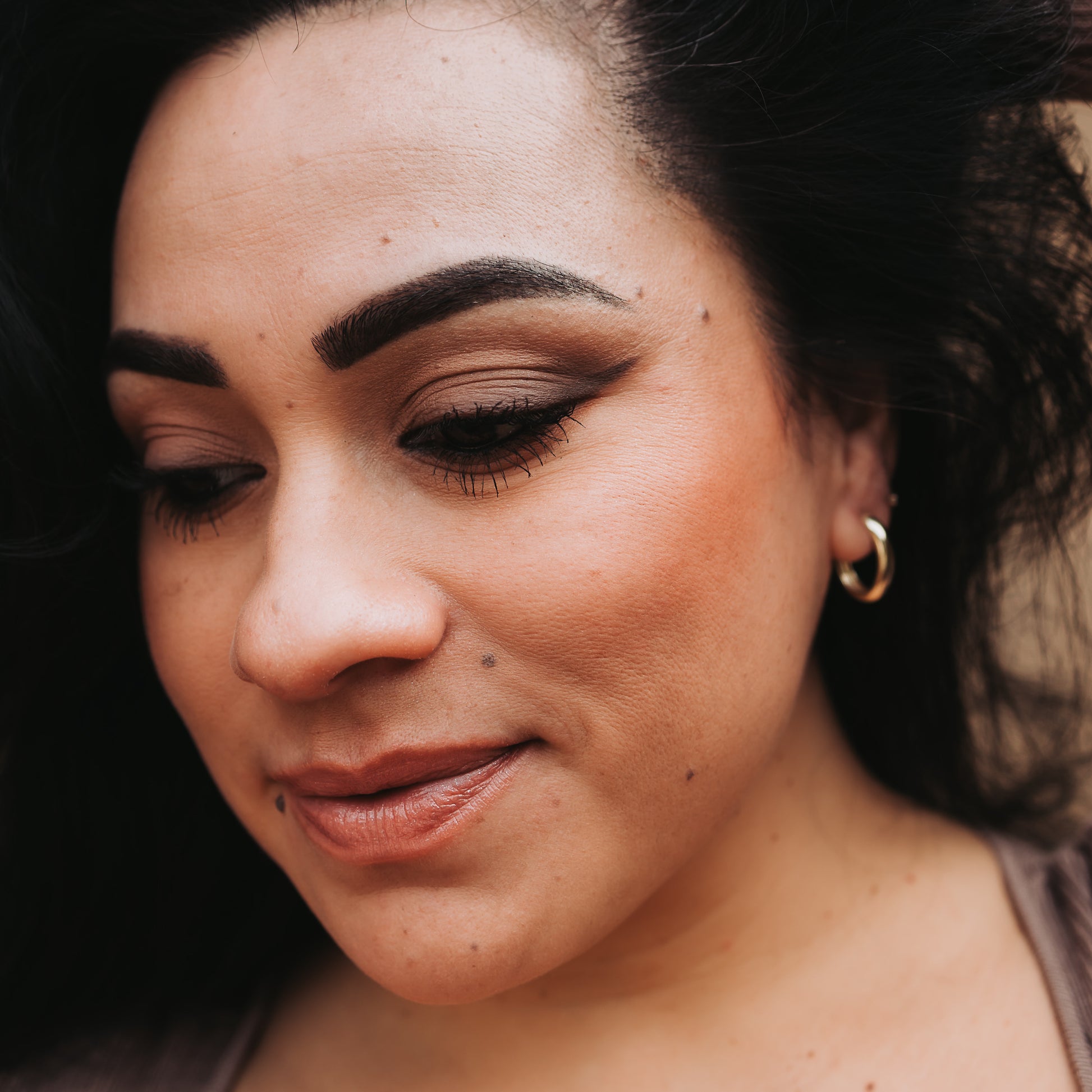 Person wearing a small hoop earring