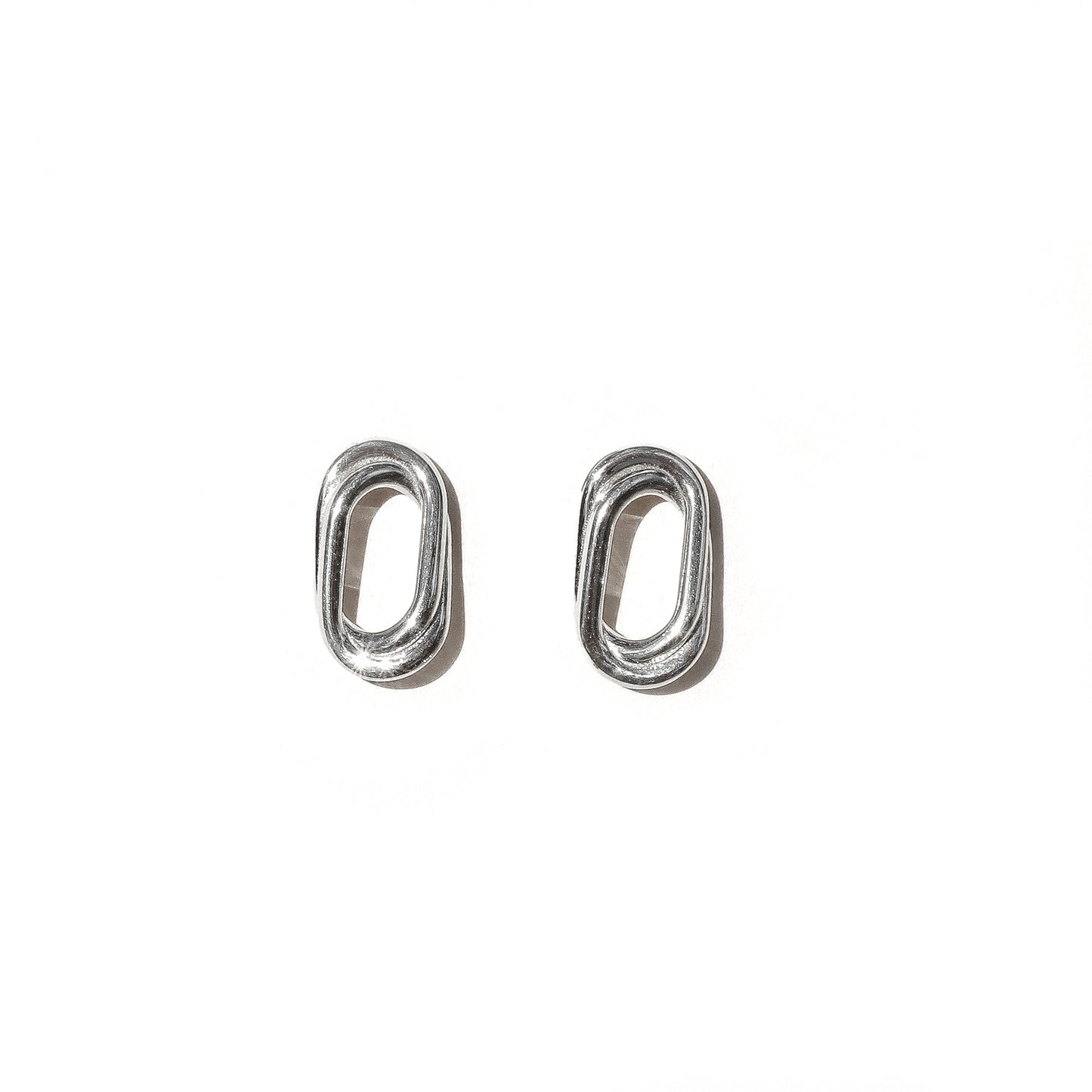 A pair of silver double oval earrings on a white background