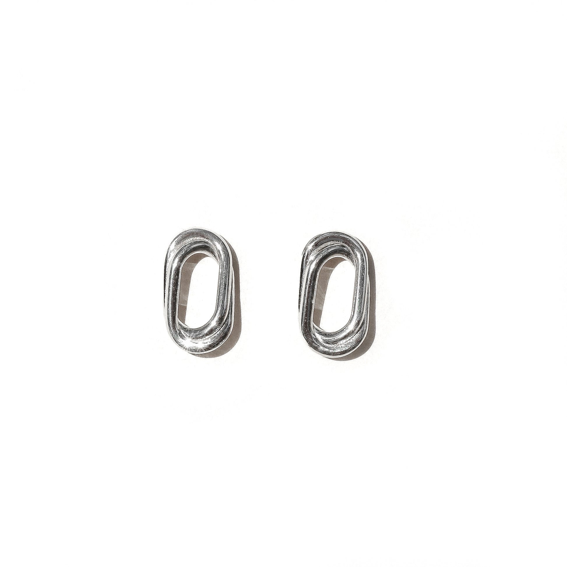 A pair of silver double oval earrings on a white background