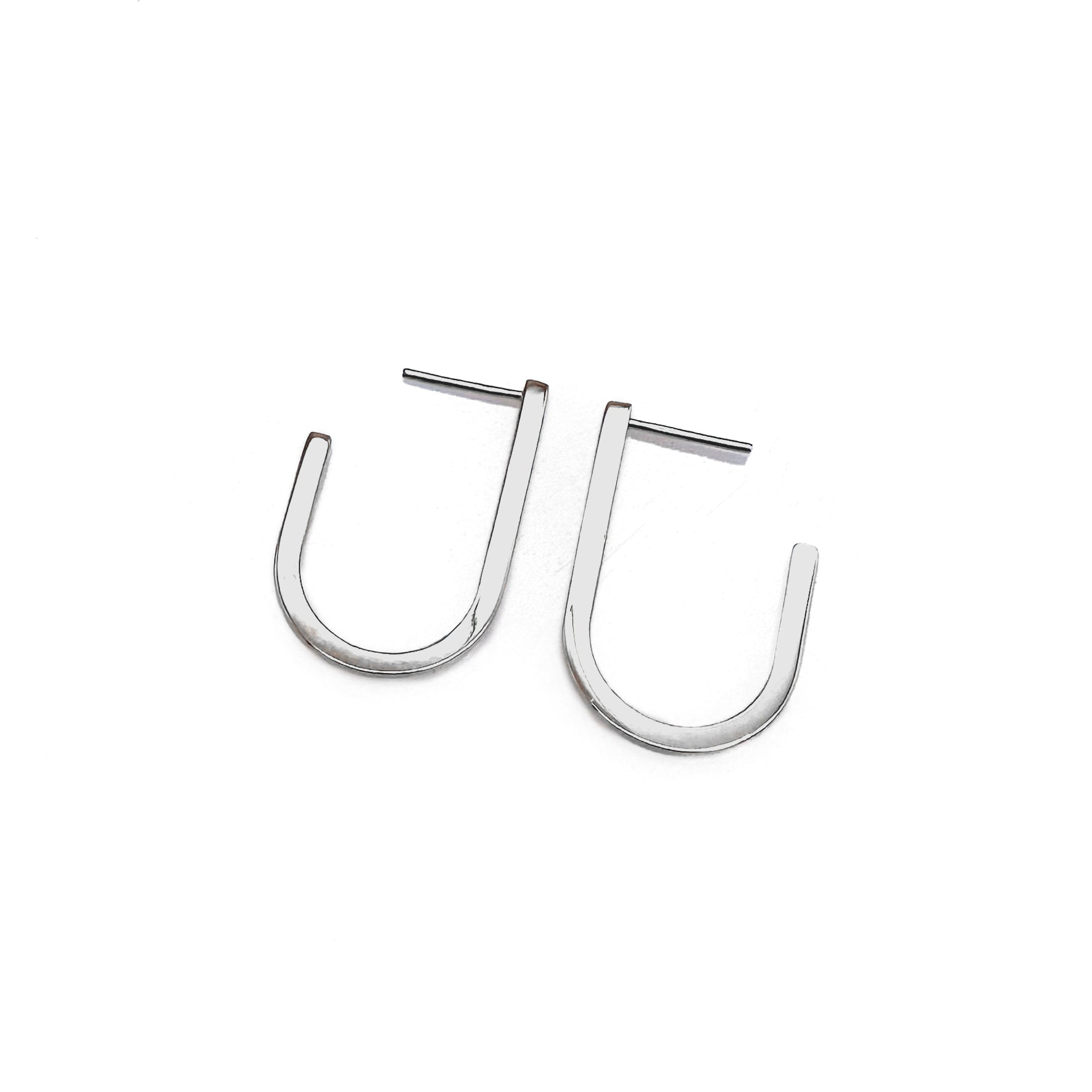 A pair of silver modern hoop earrings with a U-shape design, displayed against a white background.