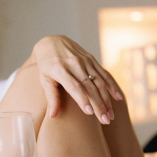 Close up of a hand wearing a silver ring