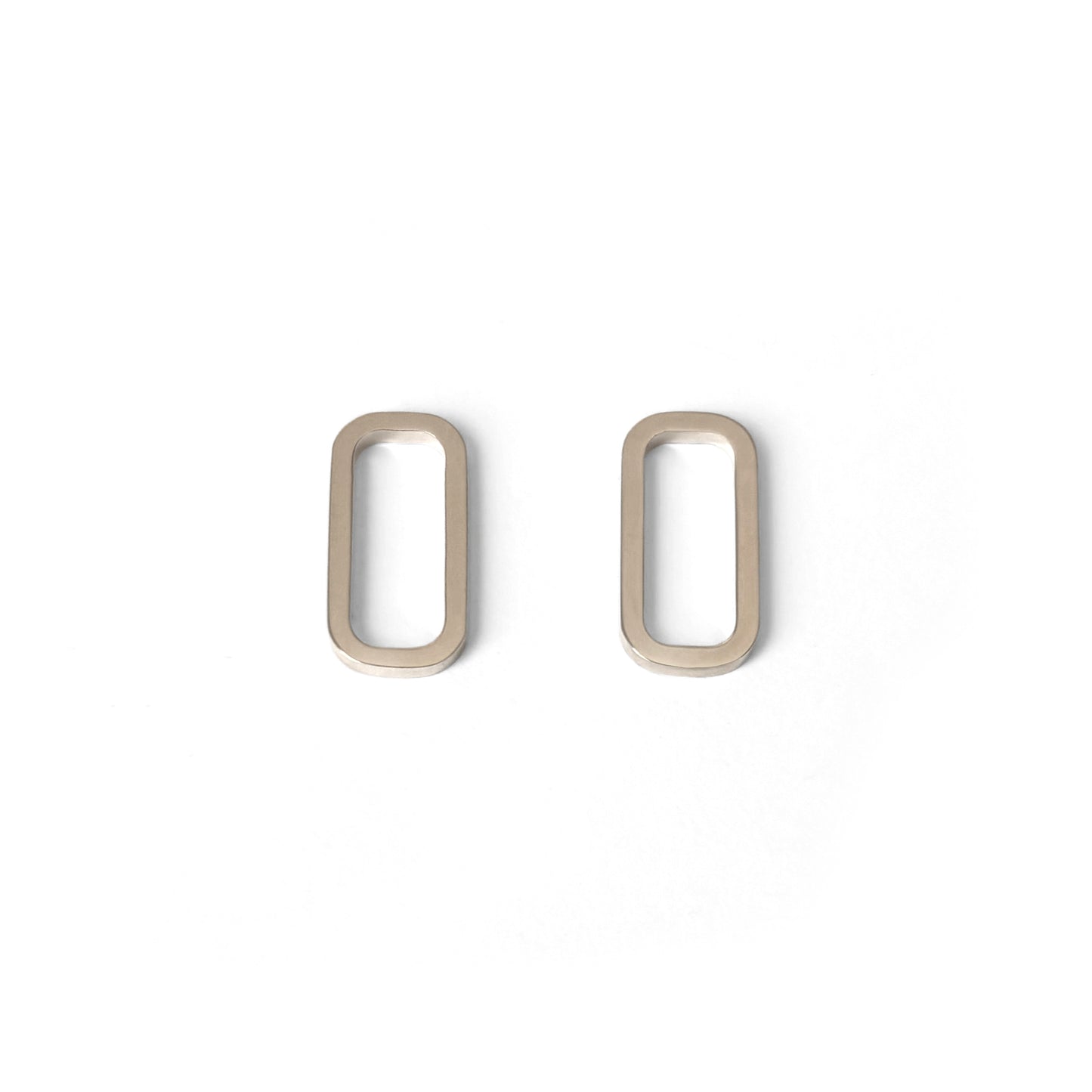 A pair of minimal rectangular geometric earrings in gold vermeil displayed against a white background.