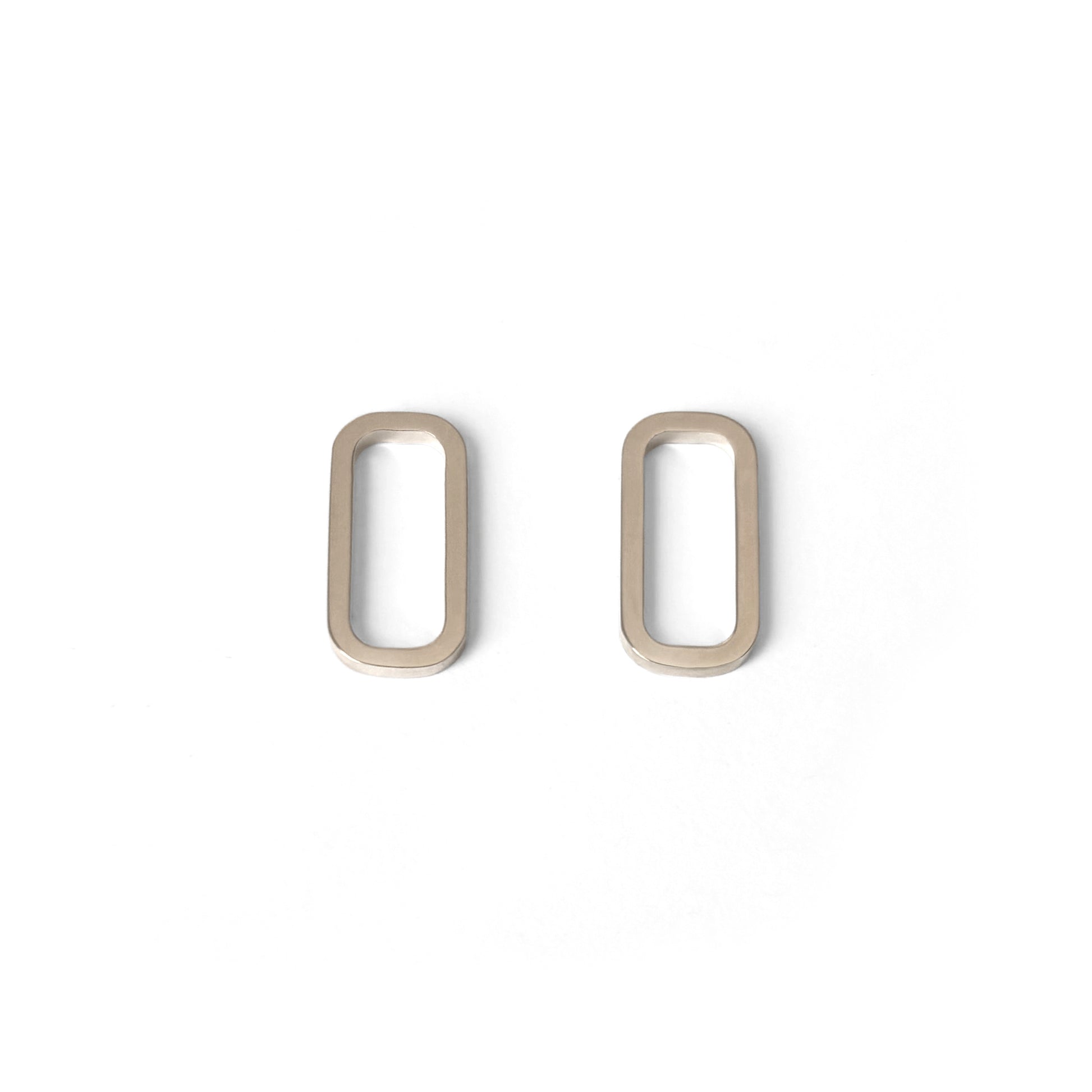 A pair of minimal rectangular geometric earrings in gold vermeil displayed against a white background.