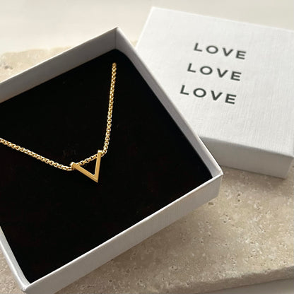 Gold triangle necklace in a white box with 'LOVE' text
