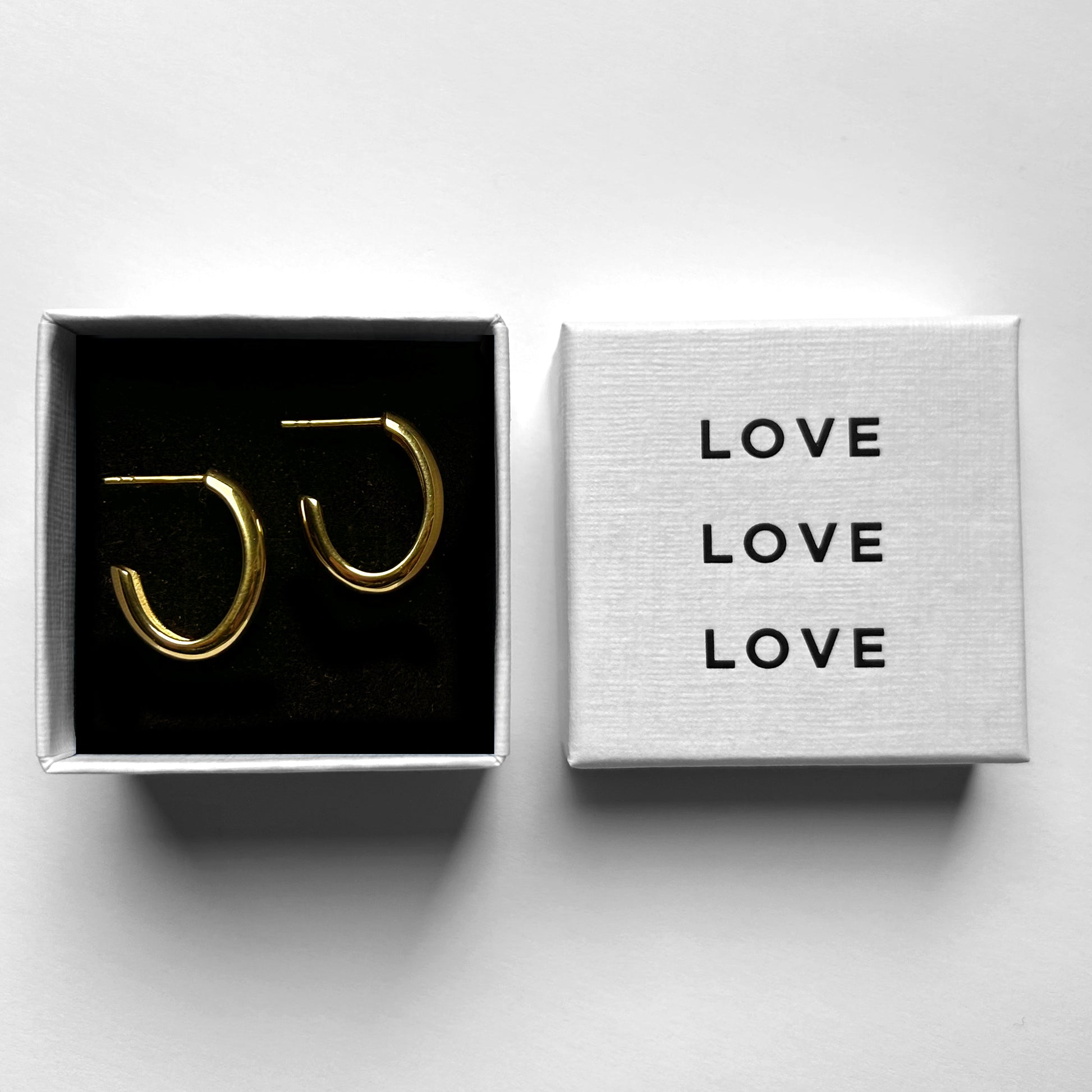 Modern Gold Hoop Aura Earrings shown in love jewelry box