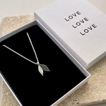 Silver leaf necklace in a box with 'LOVE' text