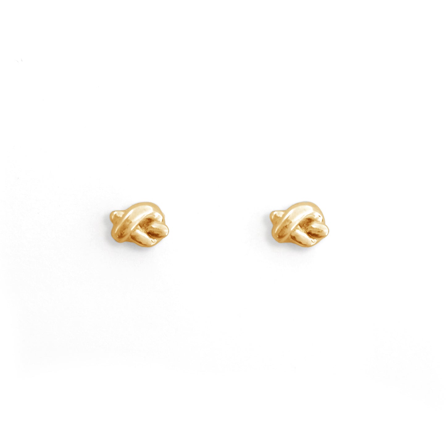 Pair of gold earrings on a white background