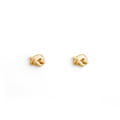 Pair of gold earrings on a white background