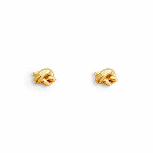 Pair of gold earrings on a white background