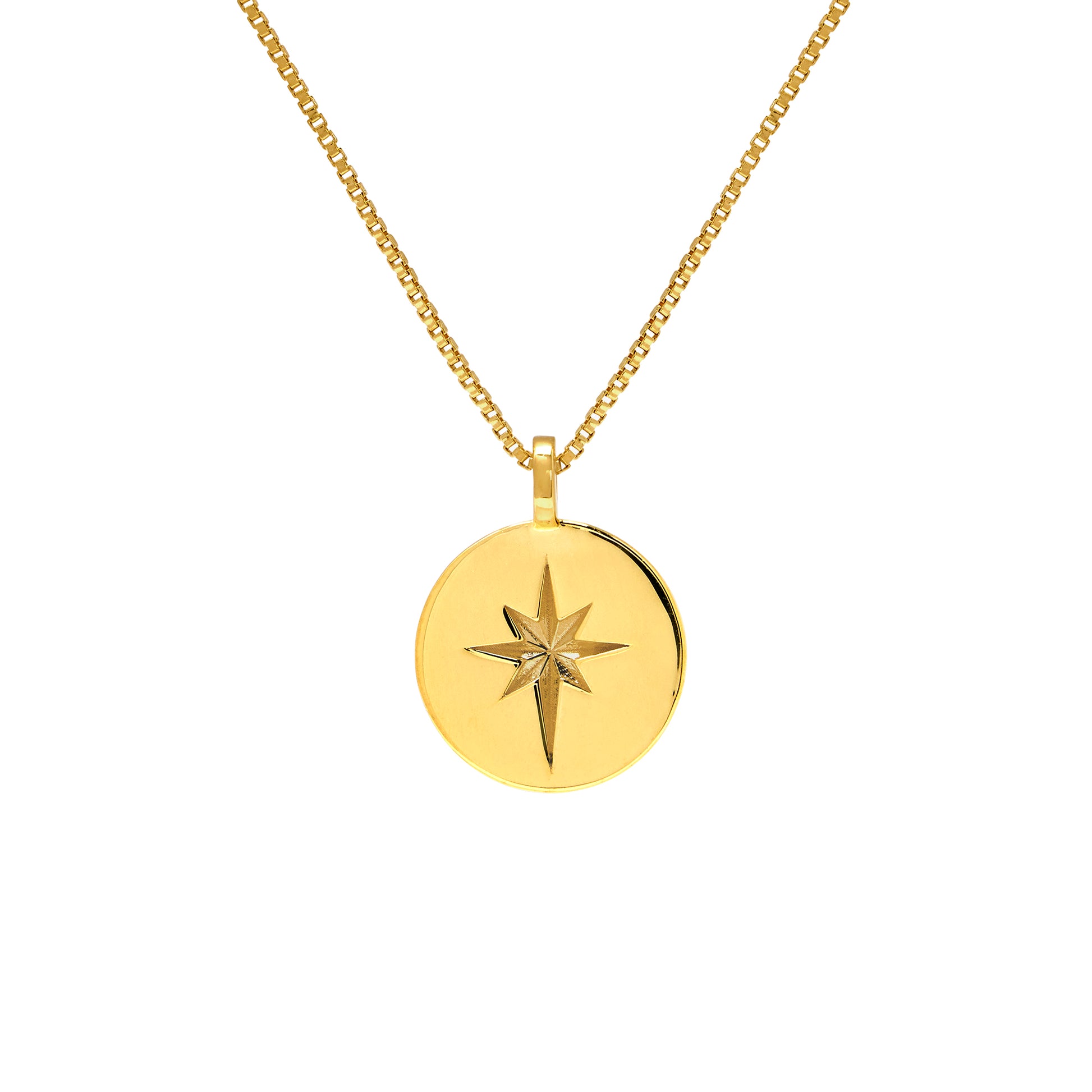 Gold necklace with a round pendant featuring a star design on a white background