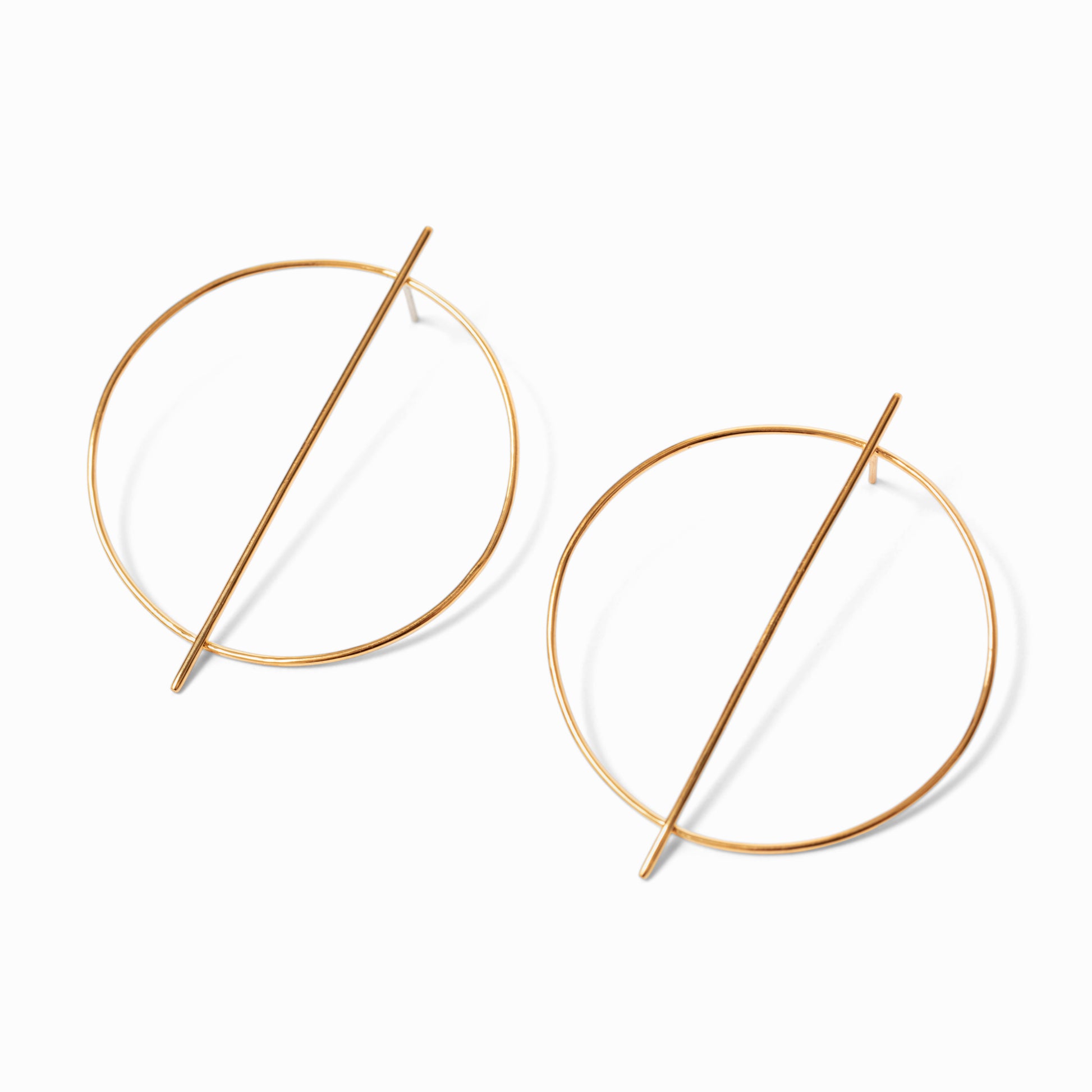 A pair of gold-colored hoop earrings with a minimalist line design