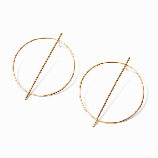 A pair of gold-colored hoop earrings with a minimalist line design