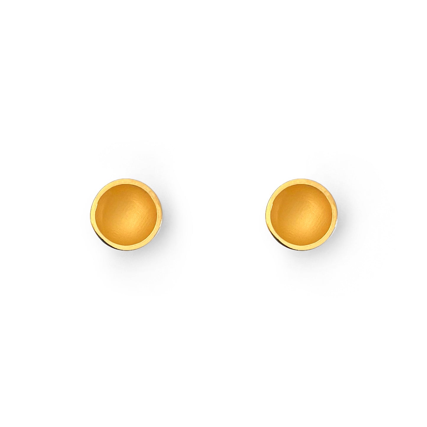 Pair of gold round earrings on a white background