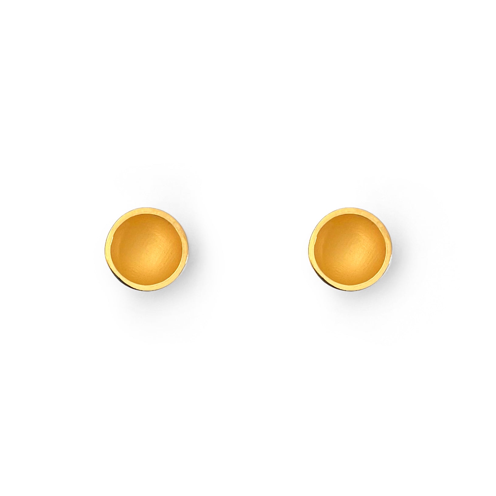 Pair of gold round earrings on a white background